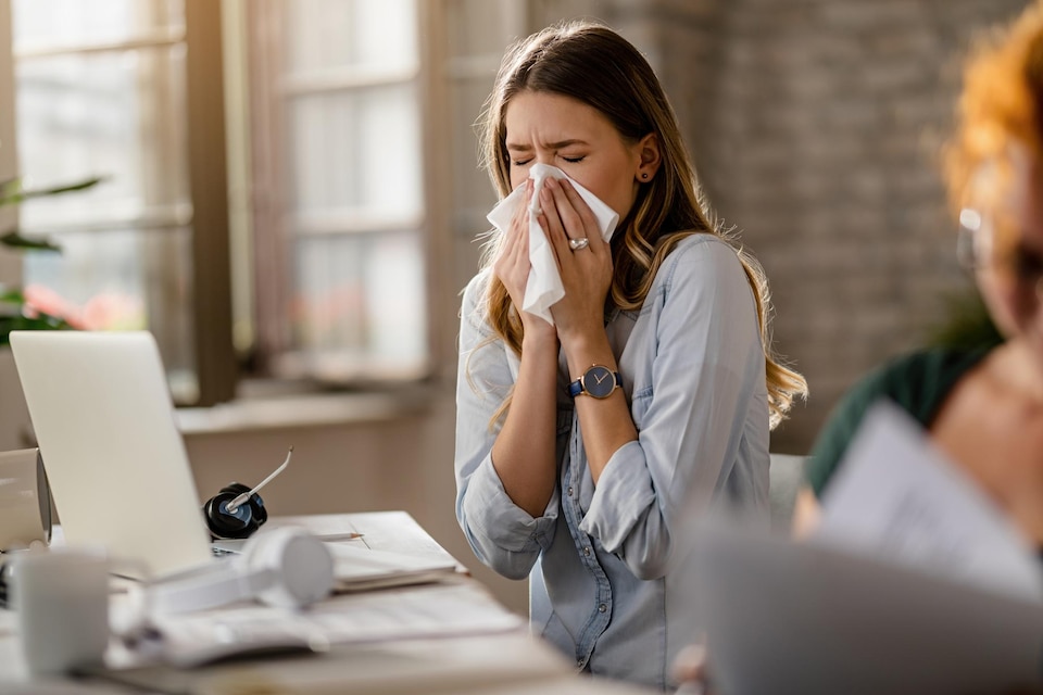 sneezing women with allergy